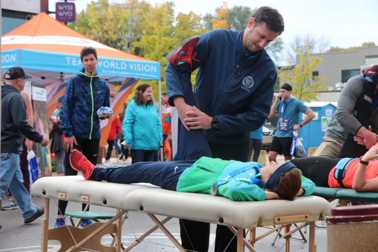 Man assisting a runner