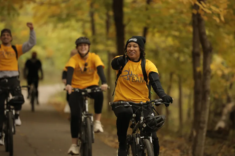 woman on a bike pointing at the camera