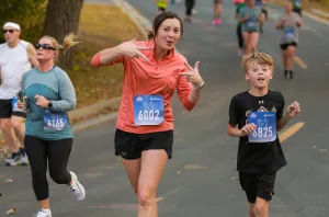 a mother and son running and smiling at the camera
