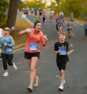 a mother and son running and smiling